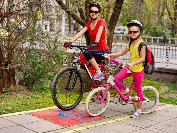 Family bike ride. Family wearing bicycle helmet with rucksack.