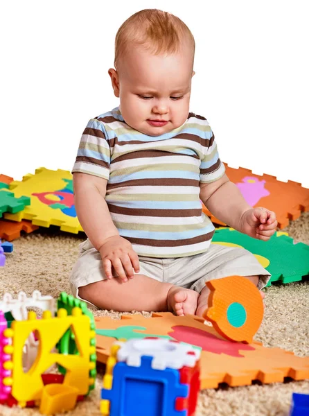 Baby making puzzle. Child jigsaw develops children. — Stock Photo, Image