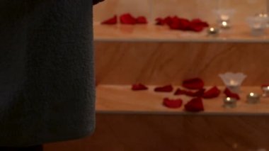 Spa yaprakları çiçek ve candels. Kadın banyoda basamaklardan.