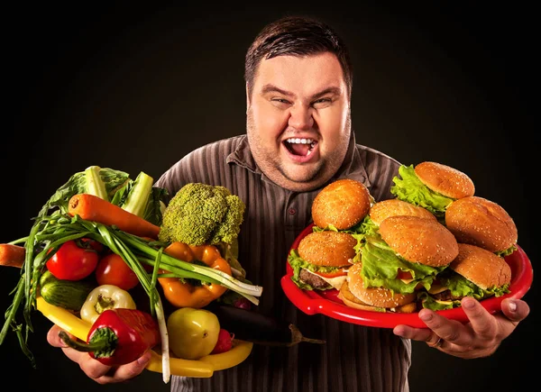 Diet fat man makes choice between healthy and unhealthy food.