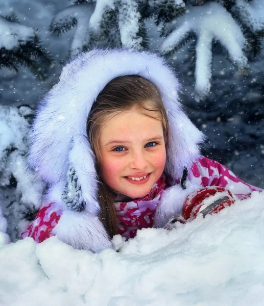 Inverno com neve para criança menina em roupas perto de árvore no parque . — Fotografia de Stock