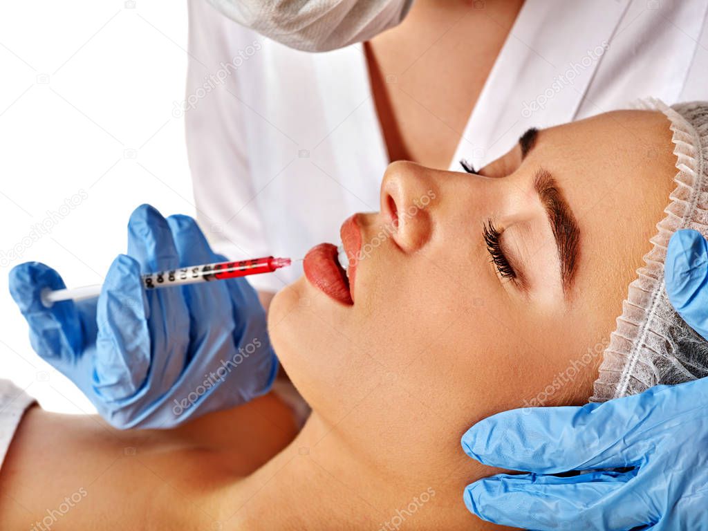 Dermal fillers lips of woman in spa salon with beautician.