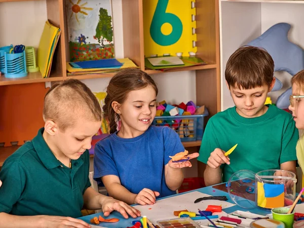 Plastilina modelado de arcilla en la clase de niños. Profesor enseña en la escuela . —  Fotos de Stock