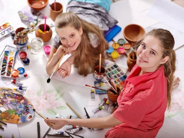 Authentic artist children girl paints on floor. Top view. — Stock Photo, Image
