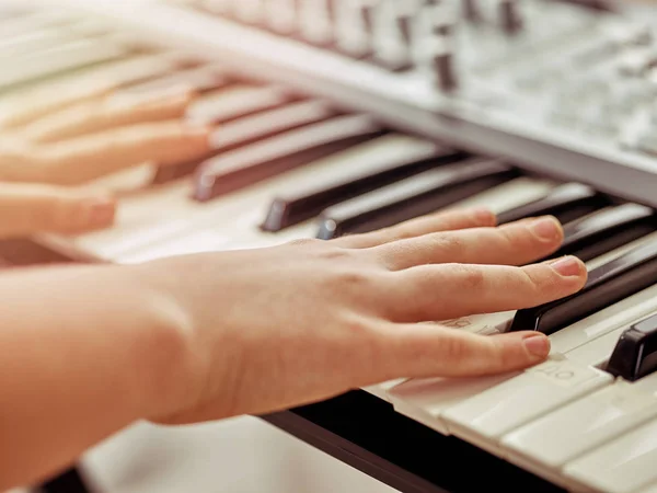 Midi keyboard or electronic piano and playing child hands. — Stock Photo, Image