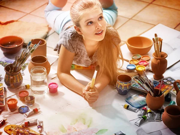 Authentic artist children girl paints on floor. Top view. — Stock Photo, Image