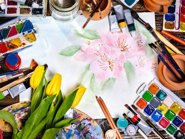 Authentic paint brushes still life on table in art class school.