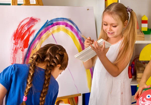 Children painting finger on easel. Group of kids with teacher. — Stock Photo, Image