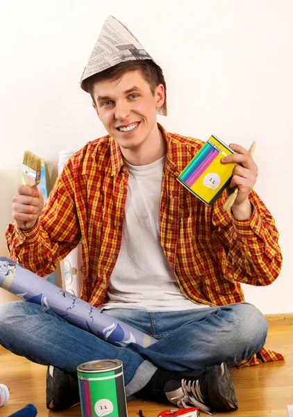 Repair home man holding paint roller for wallpaper. — Stock Photo, Image