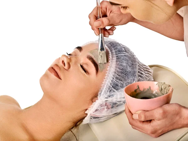 Máscara facial de barro de la mujer en el salón de spa. Masaje facial . — Foto de Stock