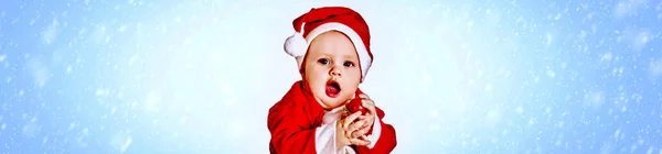 # Baby boy in Santa Claus costum on blue snowflake background # — Stok Foto