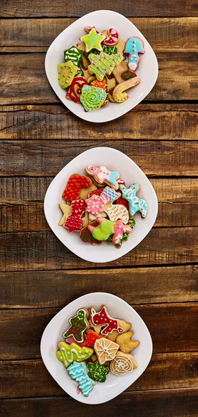 Biscoitos de gengibre de Natal em três pratos por mesa de madeira — Fotografia de Stock