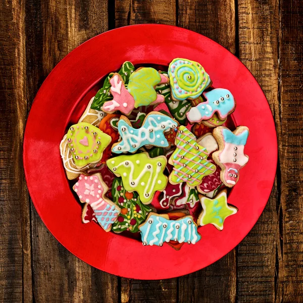 Galletas de jengibre de Navidad en plato rojo de Navidad — Foto de Stock