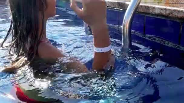 Slow motion of girl climbing out of swimming pool — Stock Video