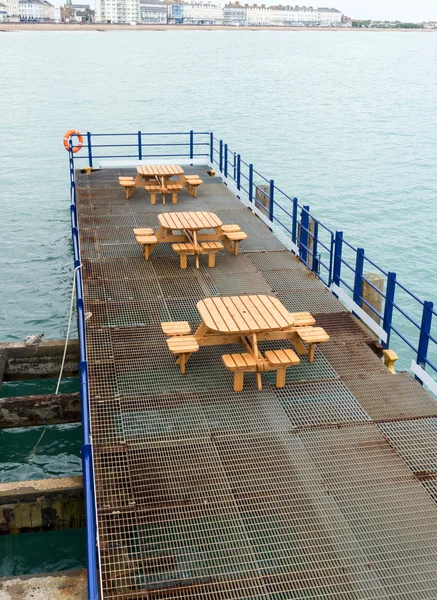 Deserted seats and tables on pier in Eastbourne UK — Stock Photo, Image