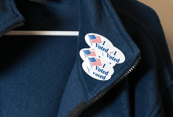 Many I Voted stickers on blue jacket hung on hanger — Stock Photo, Image