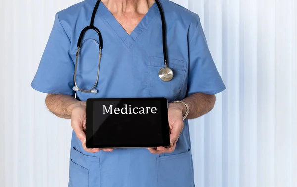 Senior doctor in scrubs facing camera — Stock Photo, Image