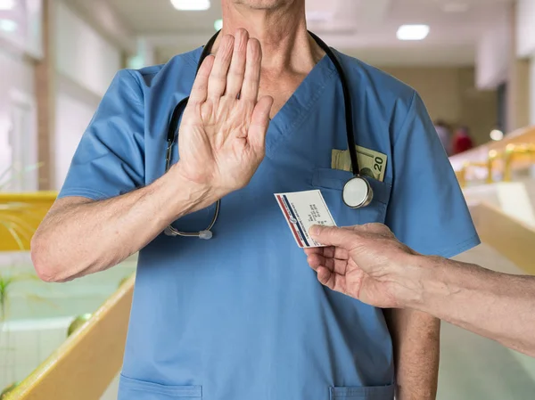 स्क्रब में सीनियर डॉक्टर मेडिकेयर कार्ड से इनकार कर रहा है — स्टॉक फ़ोटो, इमेज