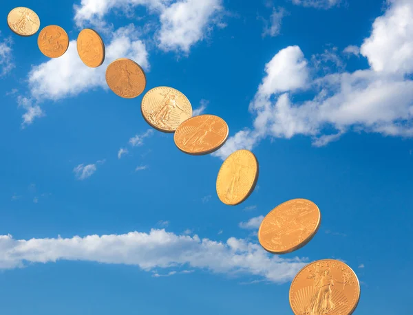 Stream of gold coins falling from blue sky — Stock Photo, Image