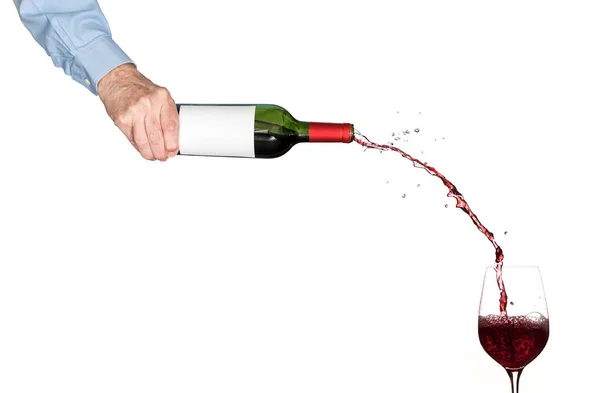 Wine pouring from bottle into glass — Stock Photo, Image