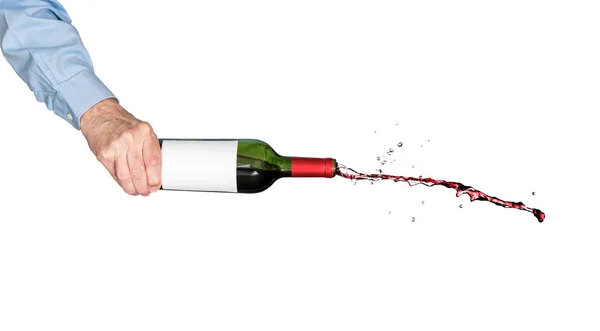 Red wine pouring out of a bottle held by hand — Stock Photo, Image