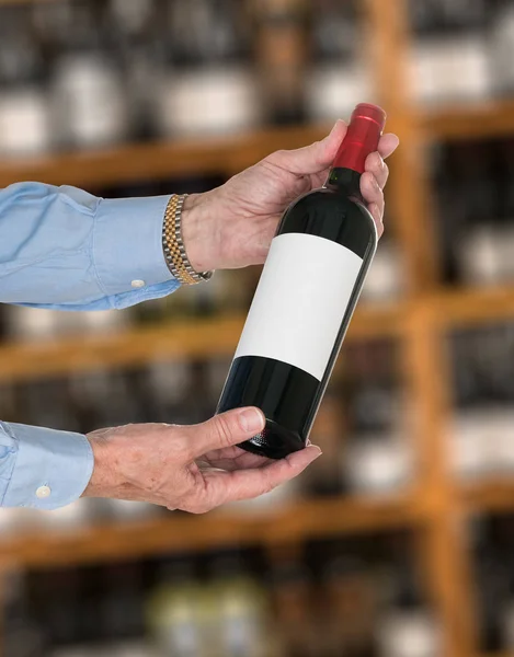 Sommelier offering bottle of red wine to customer — Stock Photo, Image