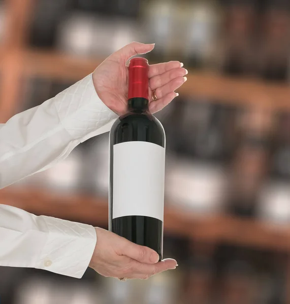 Sommelier offering bottle of red wine to customer — Stock Photo, Image