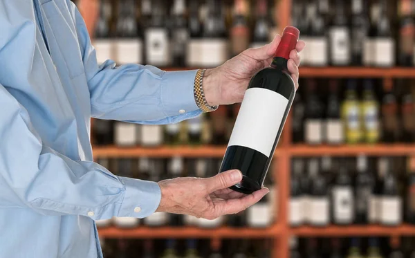 Sommelier offering bottle of red wine to customer — Stock Photo, Image