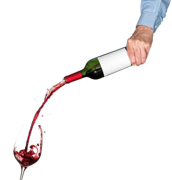 Wine pouring from bottle into glass — Stock Photo, Image