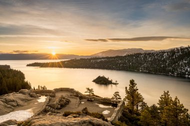 Emerald Bay on Lake Tahoe with snow on mountains clipart