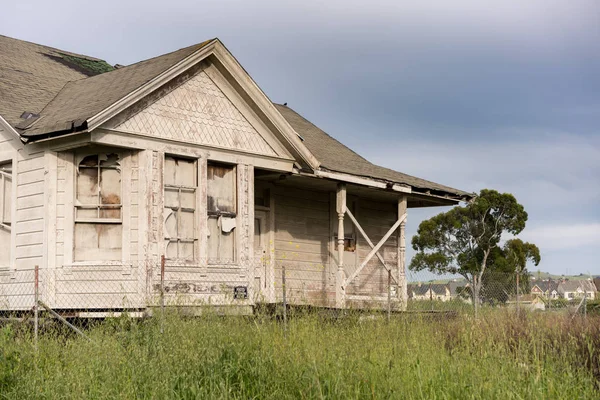 Брошенный односемейный дом с деревянным сайдингом в качестве фиксатора верхнего имущества — стоковое фото