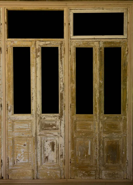 Pair of weathered french wooden doors with isolated windows — Stock Photo, Image