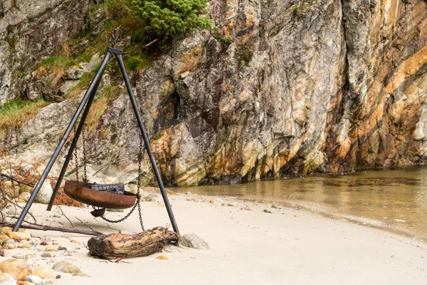 Large rusty fire pit or BBQ on beach in Norwegian fjord — Stock Photo, Image