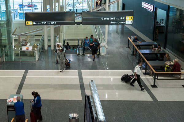 Passengers enter airport terminal to get to gates