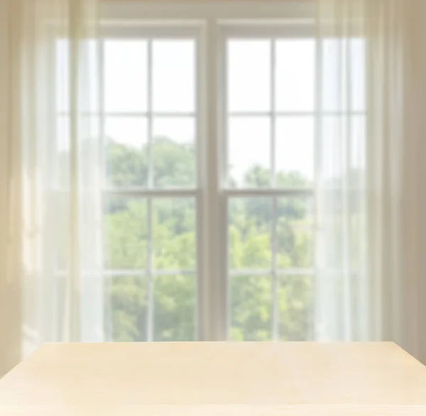 Wooden desk in front of window with space for composites