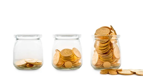 Many gold coins in three glass bottles — Stock Photo, Image