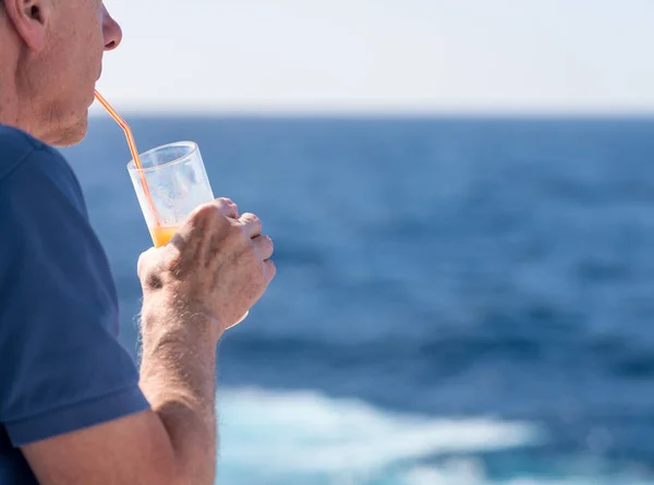 Senior caucasian adult man with tequila sunrise — Stock Photo, Image