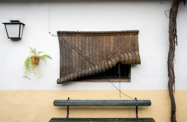 Traditional woven rush blind covering window — Stock Photo, Image