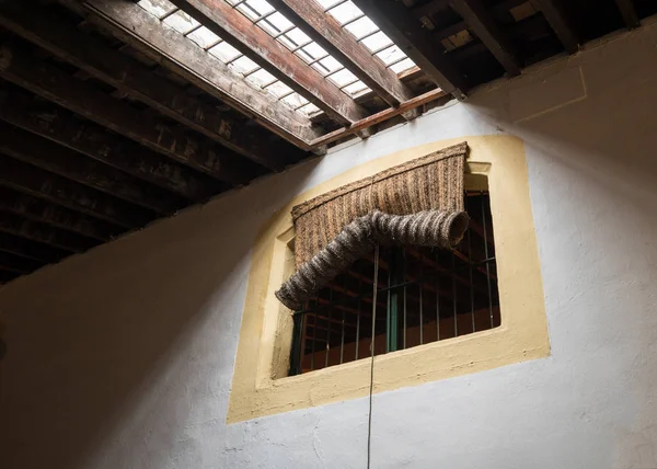 Traditional woven rush blind covering window — Stock Photo, Image