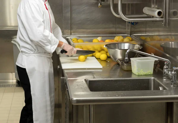 Chef preparing fruit in commercial kitchen