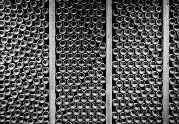 Bottoms of thousands of bottle of wine in old wine-cellar — Stock Photo, Image