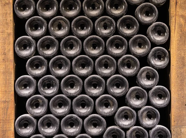 Bottoms of thousands of bottle of wine in old wine-cellar — Stock Photo, Image