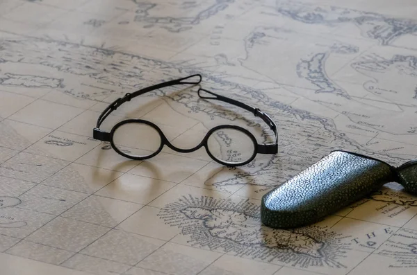 Pair of old glasses or spectacles on top of marine map — 스톡 사진