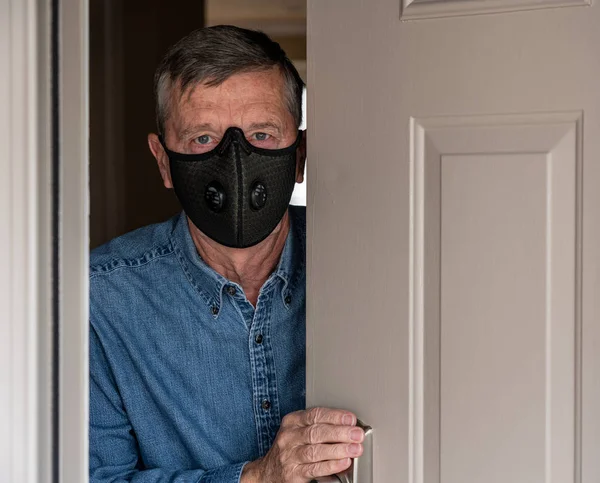 Worried senior caucasian man wearing protective mask against corona virus