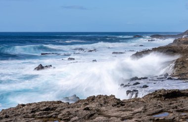 Winter waves crash on the rocky shoreline at Kaena Point on Oahu