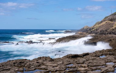 Winter waves crash on the rocky shoreline at Kaena Point on Oahu