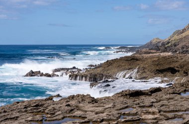 Winter waves crash on the rocky shoreline at Kaena Point on Oahu