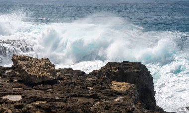 Winter waves crash on the rocky shoreline at Kaena Point on Oahu