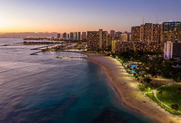 Vista aérea da praia de Waikiki em direção a Honolulu ao pôr do sol — Fotografia de Stock