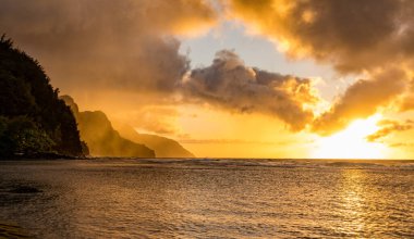 Sunset over the receding mountains of the Na Pali coast of Kauai in Hawaii